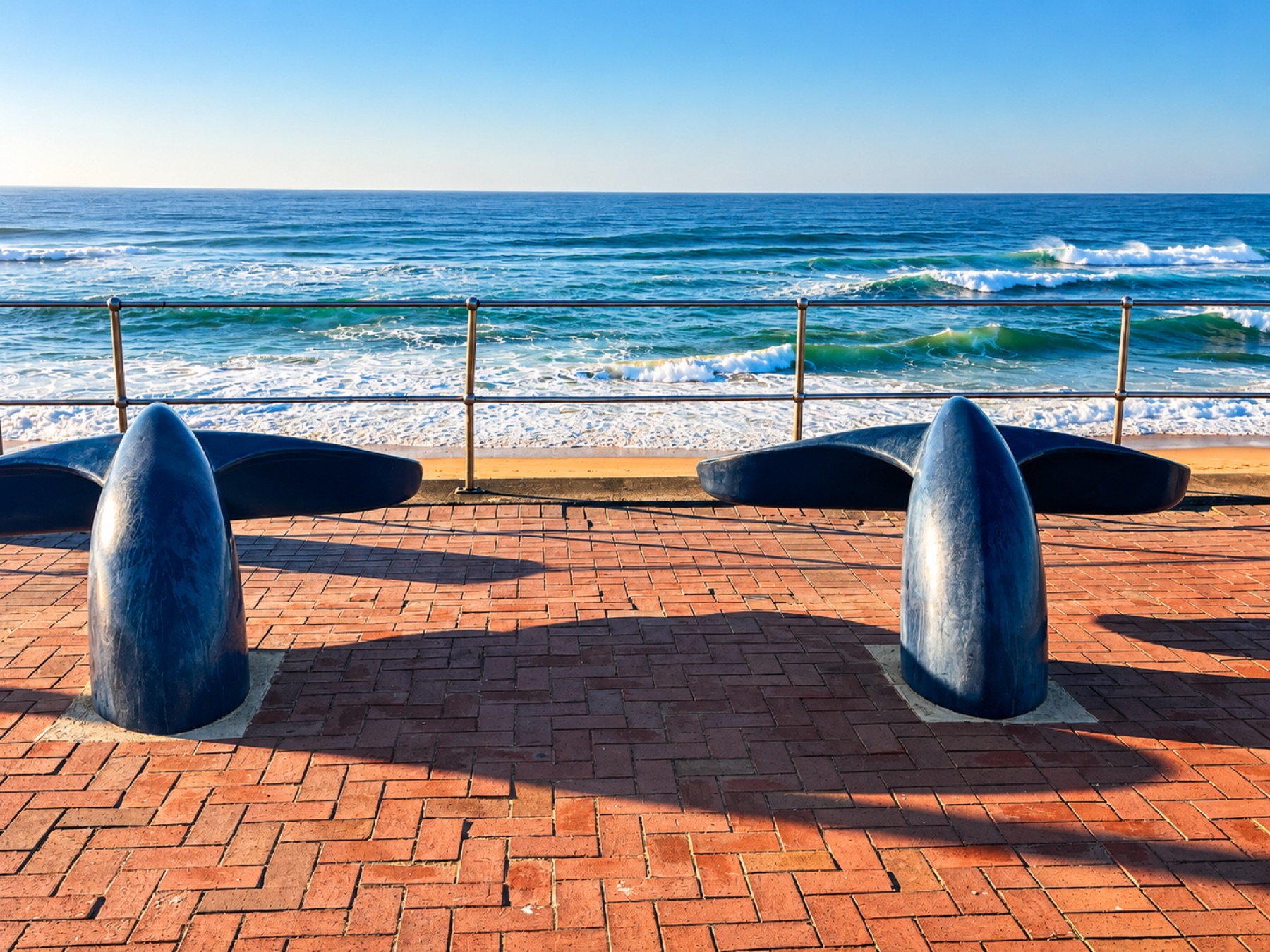 Oceanfront promenade seating beside the waves