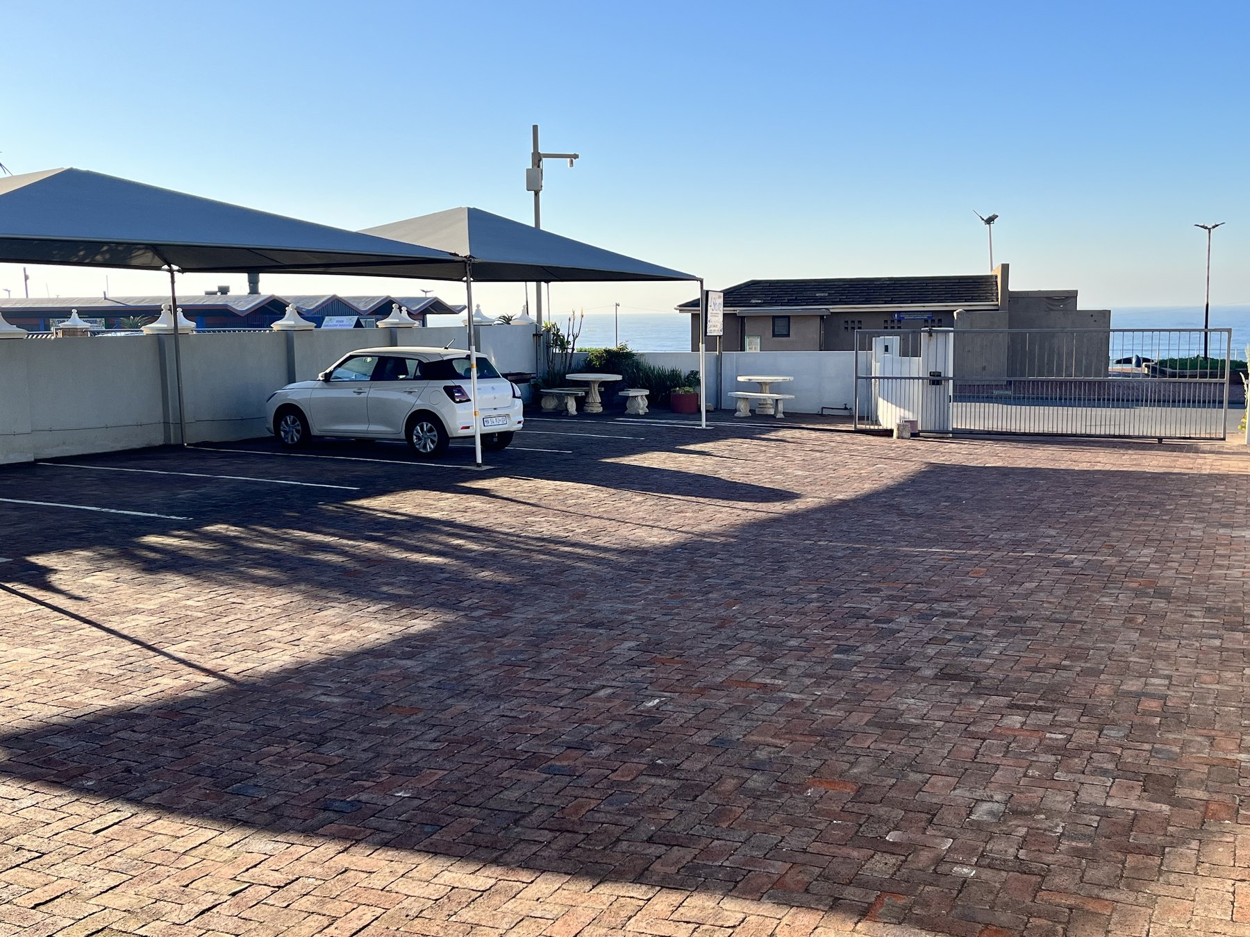 Secure on-site parking at 4Shore Guesthouse with the ocean beyond